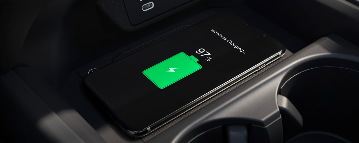 Closeup of phone charging on wireless charging pad.