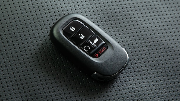 Closeup of Key FOB on perforated seat. 