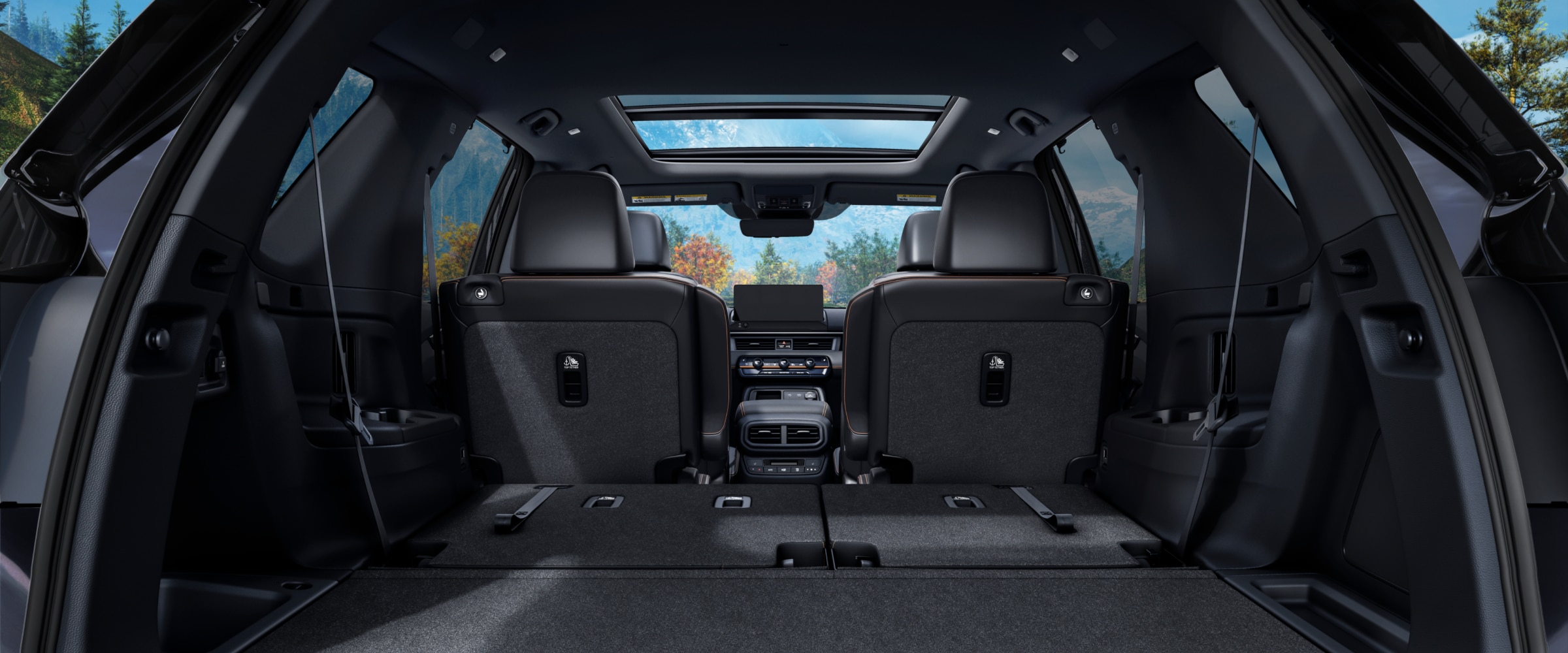 Rear view of the Pilot's interior from the open trunk, with the back row of seats folded down to showcase cargo space.