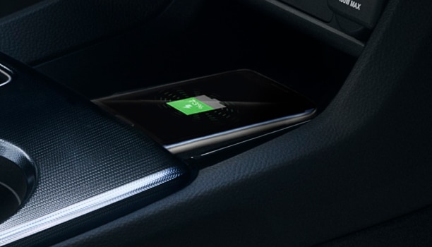 Closeup of phone charging on wireless charging pad.