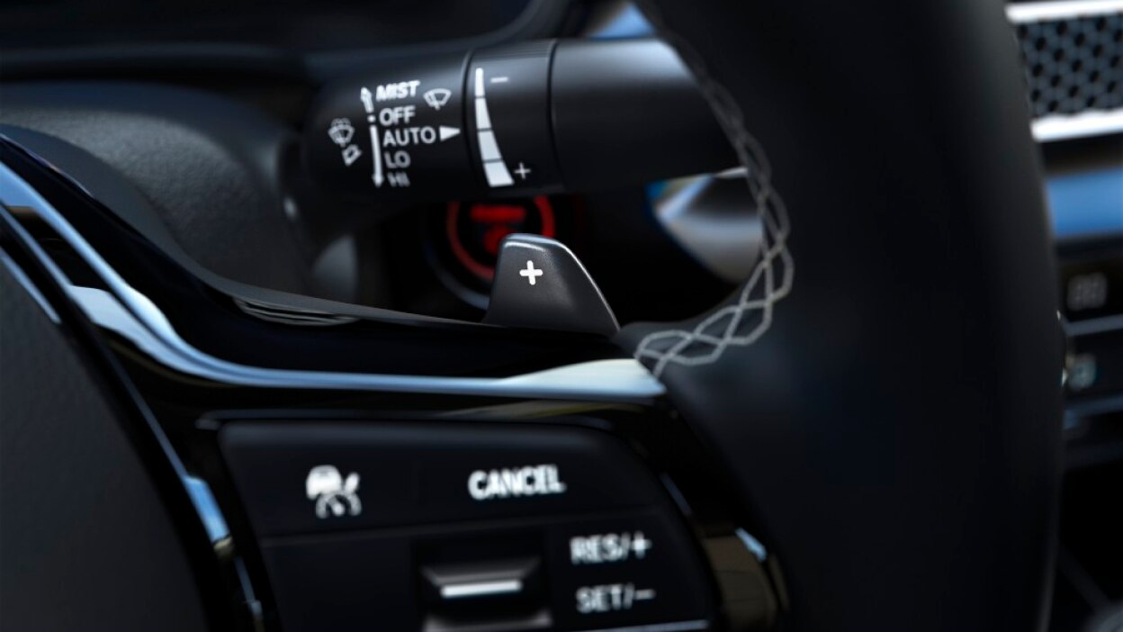 Closeup of steering wheel with paddle shifters.