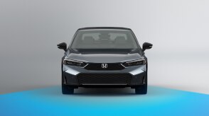 Wide front view of grey Civic Sedan on white space. Blue sensor waves emit from the front.