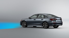 3/4 side rear view of grey Civic Sedan on white space. Blue sensor waves emit from the front. 