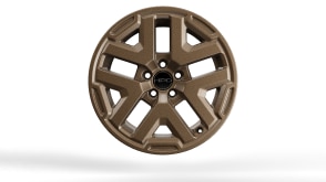  Closeup of 18-inch bronze alloy wheel on white space. 