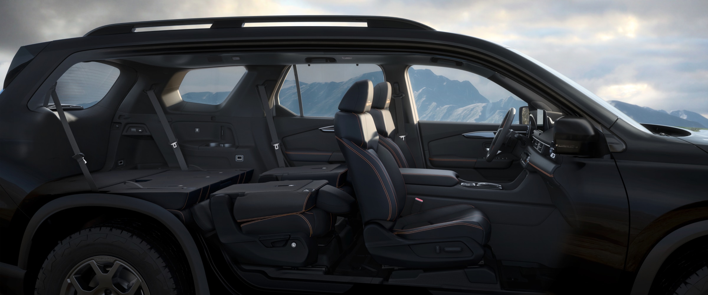 Vue latérale d’un Pilot dont les portes ont été retirées, révélant l’intérieur avec les deux rangées de sièges arrière rabattues.