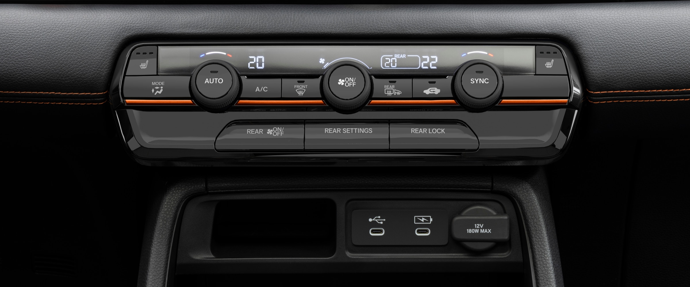 Gros plan sur le panneau de commande de la climatisation du Pilot, avec les boutons et les cadrans de réglage de la température.